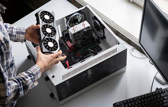 man installing new graphics card to custom computer 